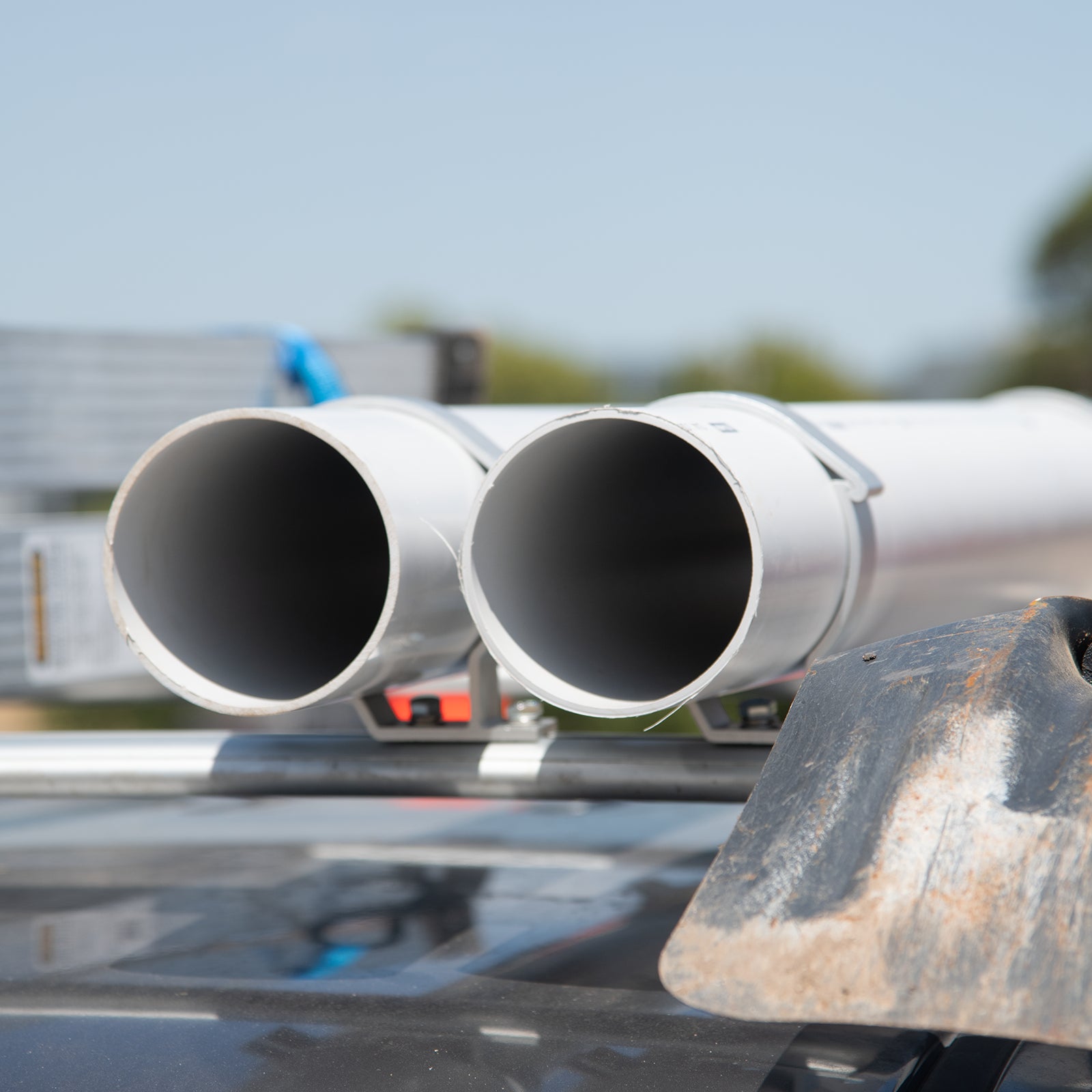 GRUNT 100mm Black Universal T Slot Conduit Carrier 2-Pack – T-slot compatible conduit and pipe holders for ute trays. Secures PVC conduit, pipes, and tubing during transport. Available at Bunnings AU and NZ.