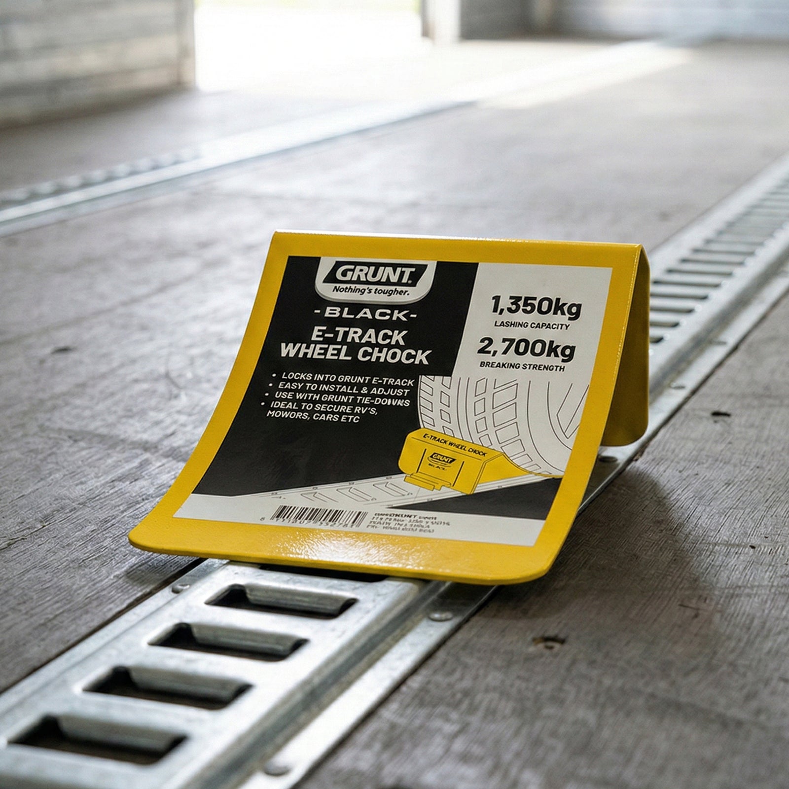 GRUNT 167mm E Track Wheel Chock – E-Track compatible wheel chock for securing motorcycles and wheeled equipment during transport. Prevents forward/backward movement on trailer beds. Available at Bunnings AU and NZ.