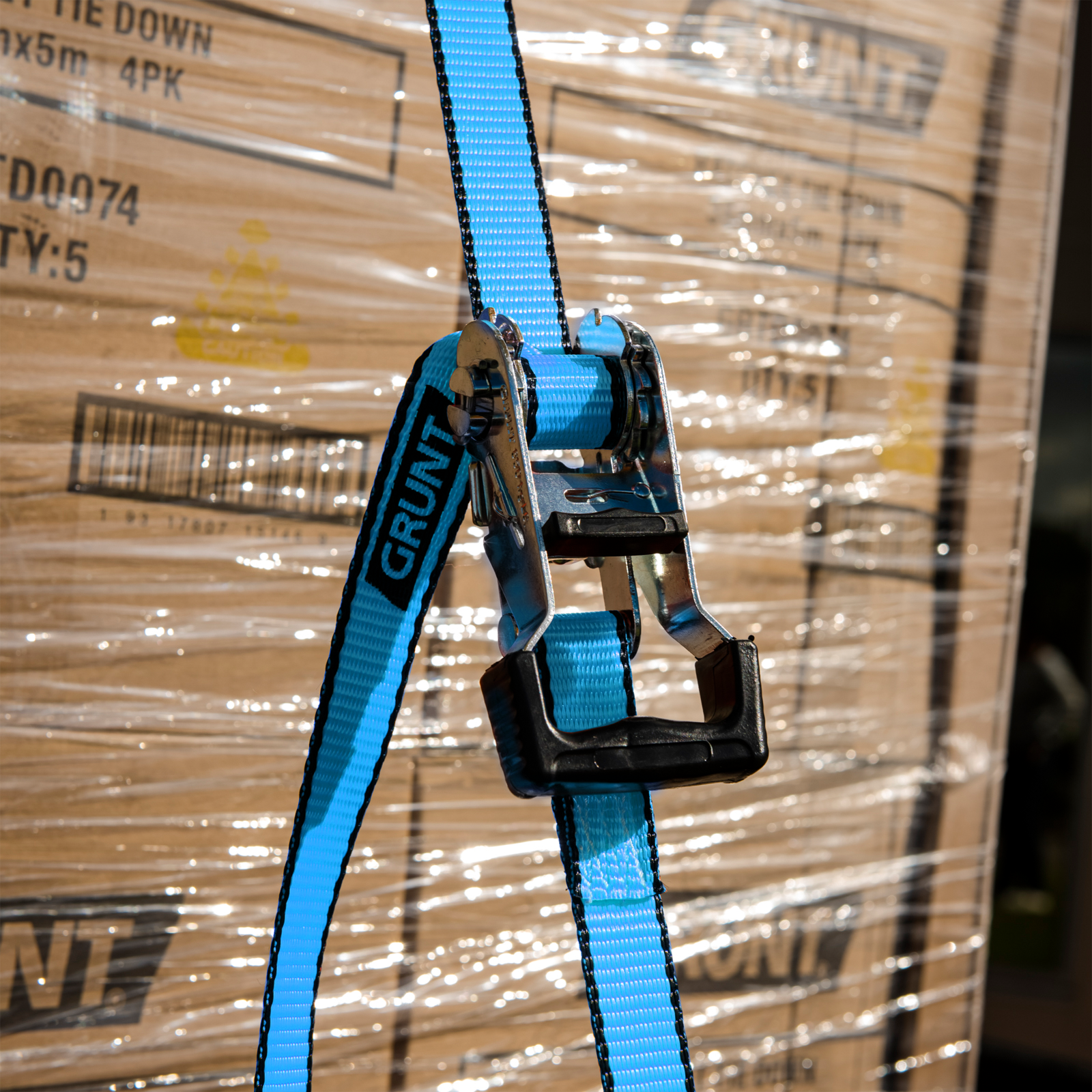 GRUNT 25mm x 4m Blue and Black Ratchet Tie Down Straps 2-Pack – compact ratchet straps for securing light-to-medium loads on trailers, utes, and roof racks. Easy-to-use ratchet mechanism. Available at Bunnings AU.