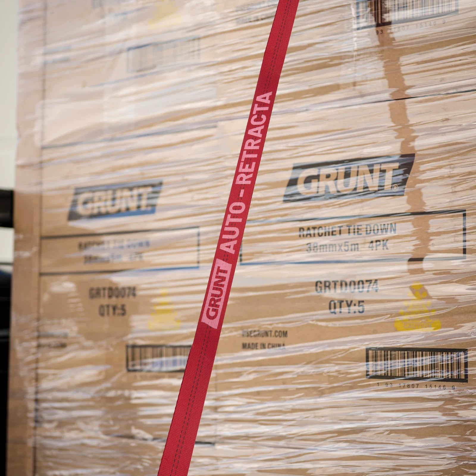 GRUNT 35mm x 5m Red Safety Auto Retractable Tie Down – self-retracting ratchet strap for tangle-free, single-hand load securing on trailers and utes. Auto-rewind for fast deployment and neat storage. Available at Bunnings AU and NZ.