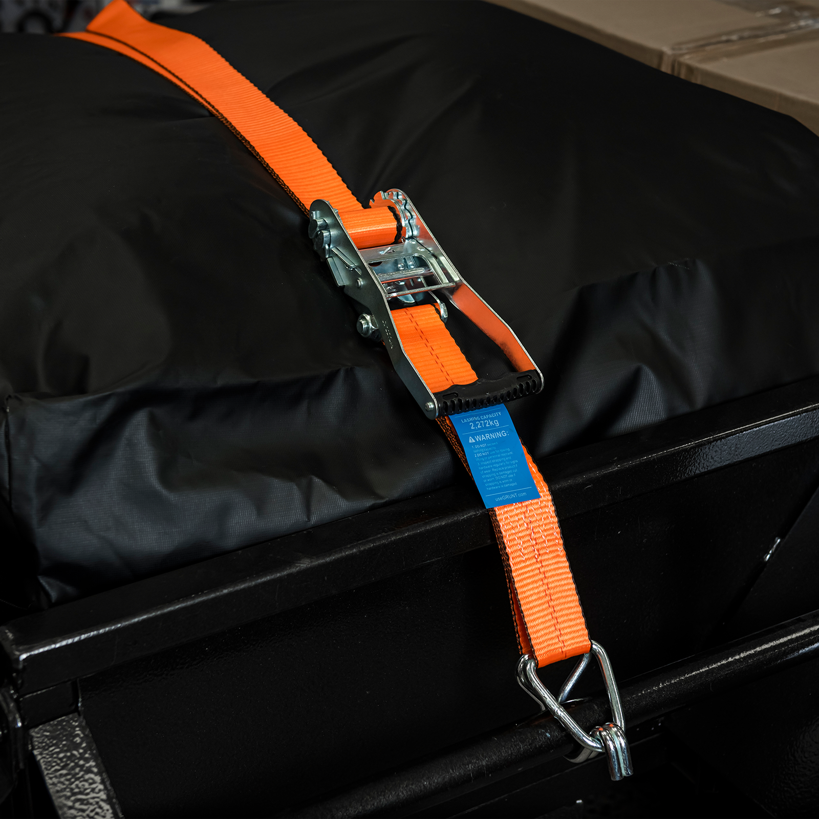 GRUNT 50mm x 8m Orange Heavy Duty Ratchet Tie Down – extra-wide long-length ratchet strap for securing heavy loads, vehicles, and machinery. High working load for professional transport. Available at Bunnings AU and NZ.