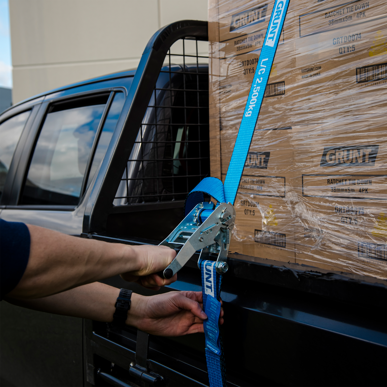 GRUNT 50mm x 9m Blue and Yellow Heavy Duty Ratchet Tie Down – long-reach extra-wide ratchet strap for securing heavy machinery, furniture, and large loads on trailers and trucks. Available at Bunnings AU and NZ.