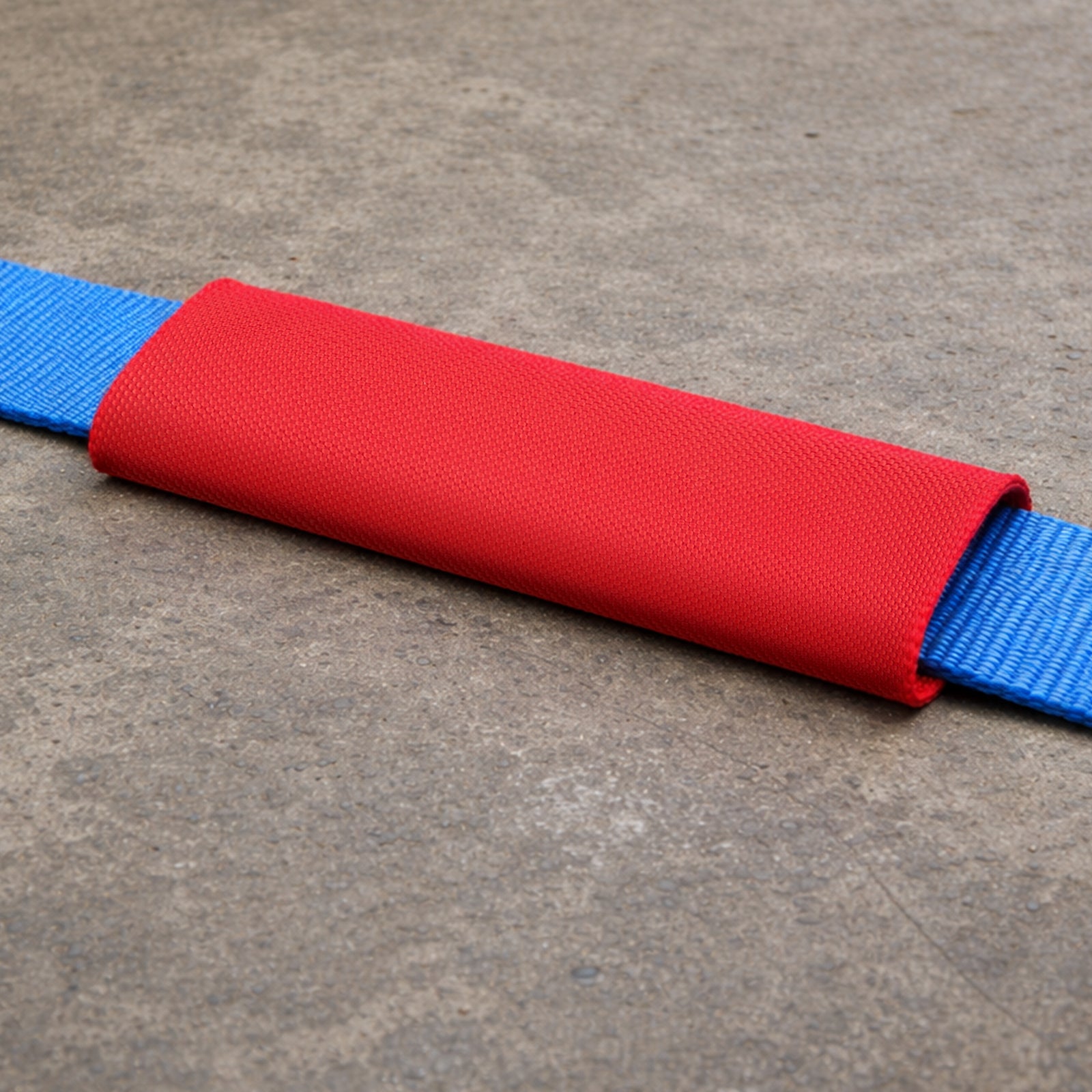 GRUNT 65mm x 25cm Red Heavy Duty Webbing Protector – durable strap sleeve to protect tie-down webbing from sharp edges and corners during load transport. Extends strap life and prevents cutting. Available at Bunnings AU.