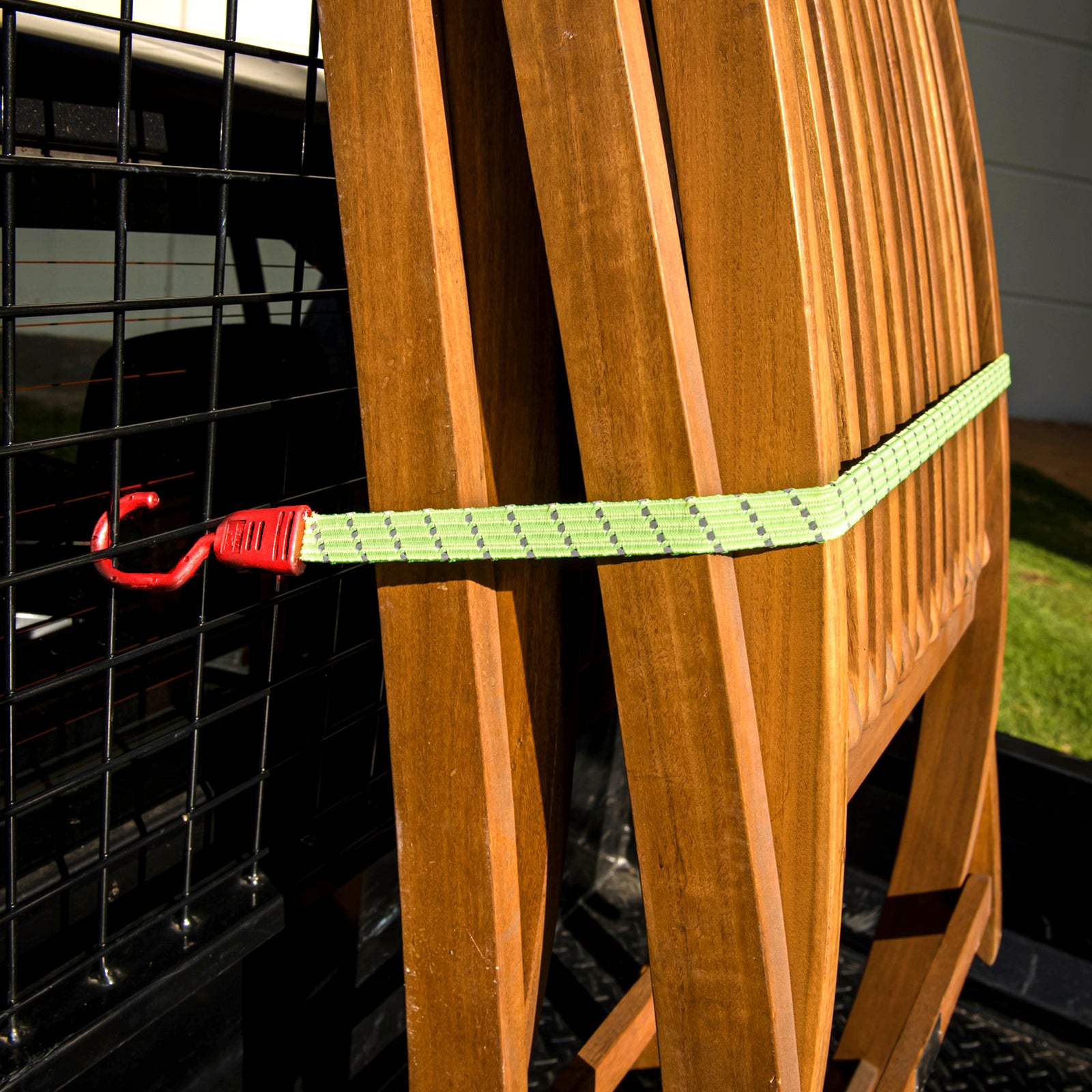 GRUNT 1m Fluro Orange Reflecta Flat Bungee Strap – long high-visibility reflective flat bungee strap for securing larger loads on trailers, racks, and utes. Day and night load safety. Available at Bunnings AU and NZ.