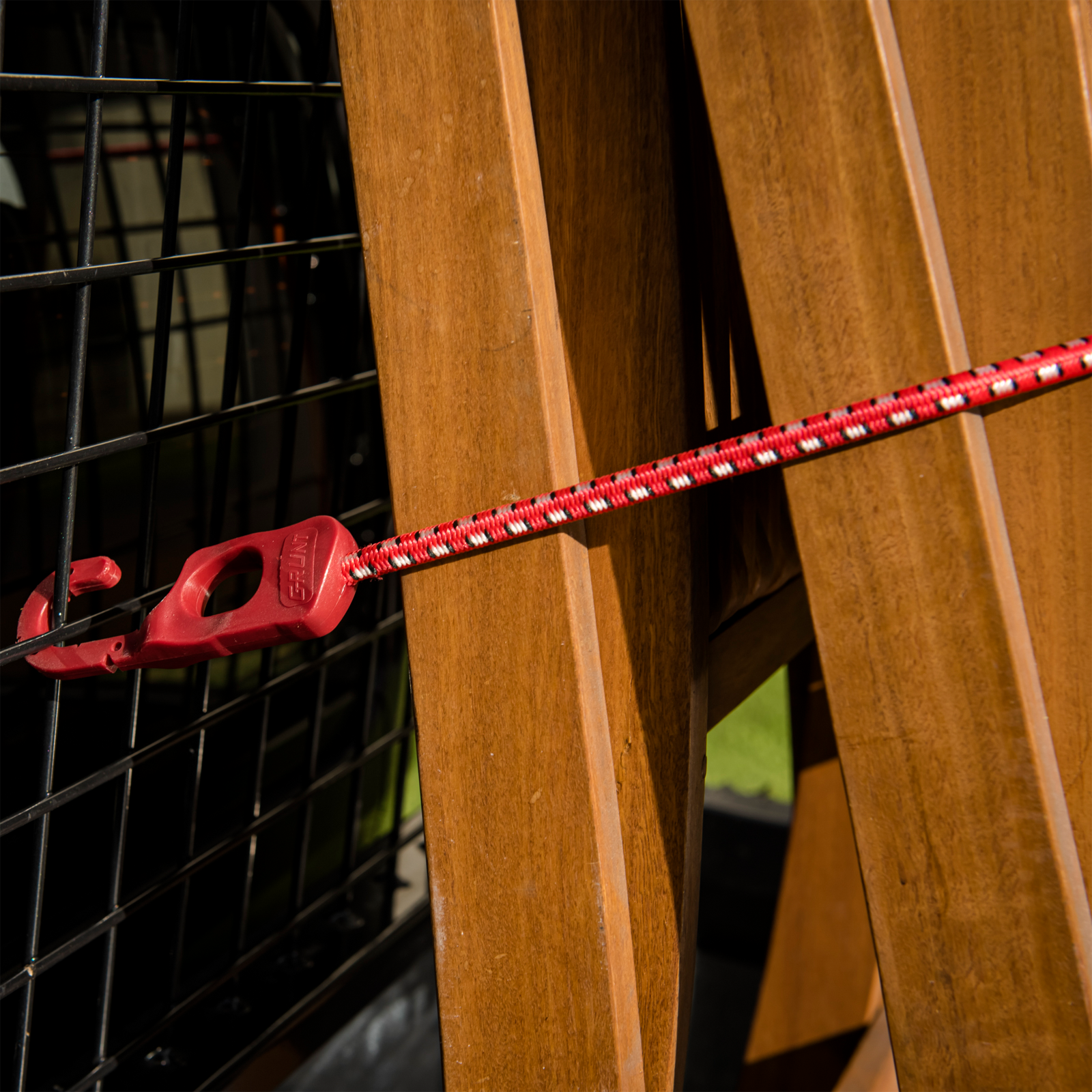 GRUNT 1200mm Red and Black Octopus Tie Down Straps 2-Pack – long multi-hook elastic bungee straps for securing large loads and bulky cargo on racks and trailers. High-visibility red for easy identification. Available at Bunnings AU and NZ.