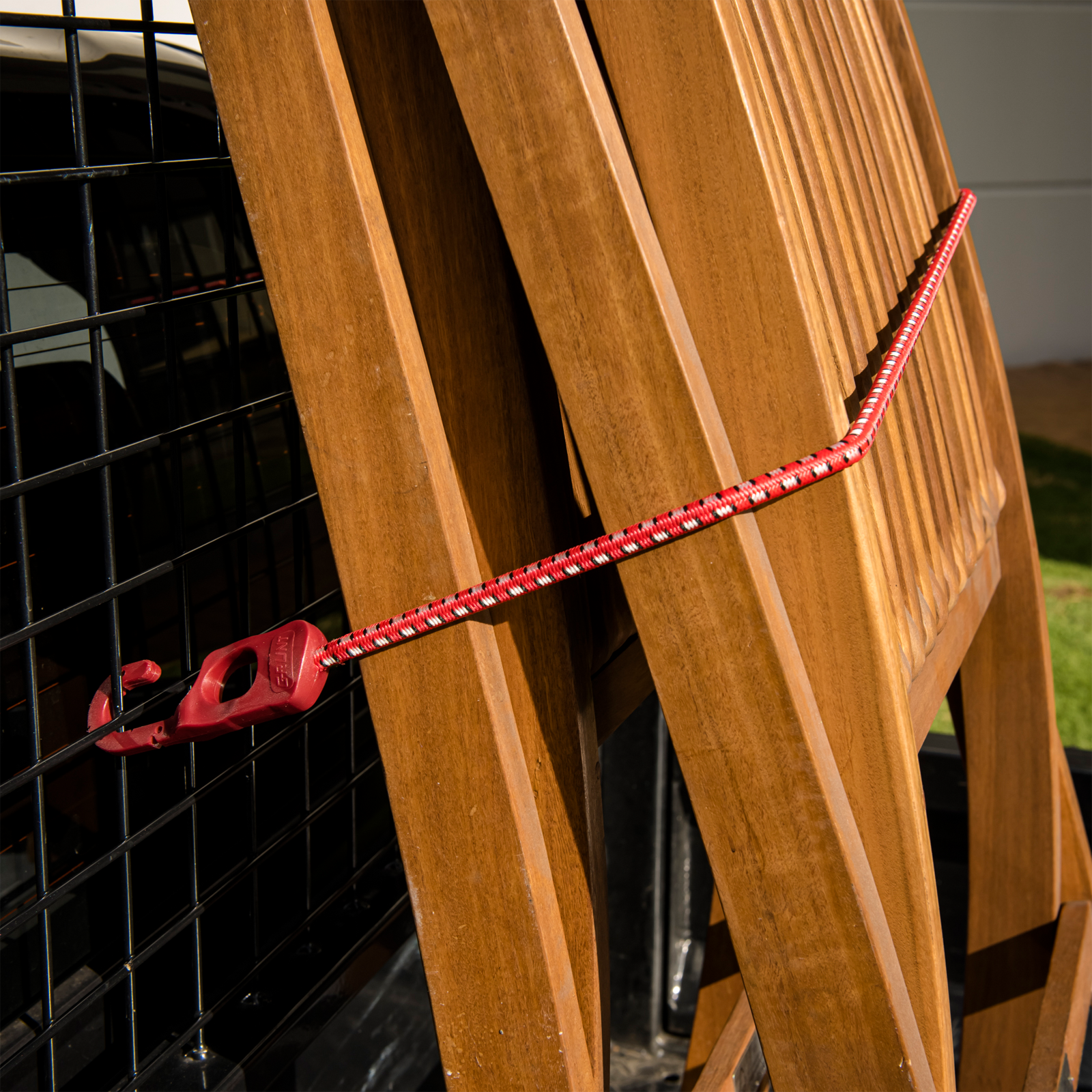 GRUNT 1200mm Red and Black Octopus Tie Down Straps 2-Pack – long multi-hook elastic bungee straps for securing large loads and bulky cargo on racks and trailers. High-visibility red for easy identification. Available at Bunnings AU and NZ.