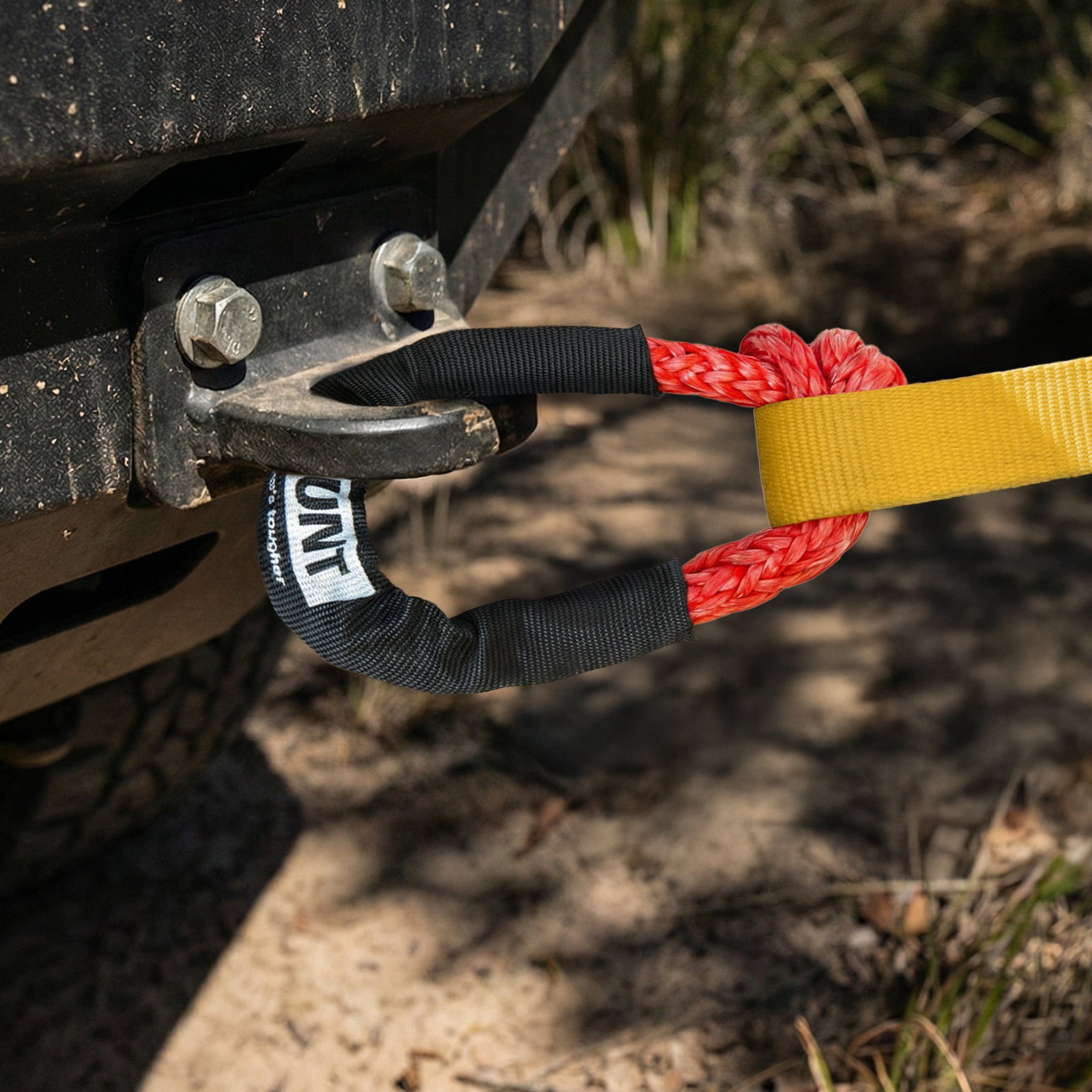 GRUNT 230mm Red and Black Soft Shackle – 8000kg rated synthetic fibre soft shackle for 4WD recovery and vehicle extraction. Lightweight, safe, and non-damaging alternative to steel shackles. Available at Bunnings AU and NZ.