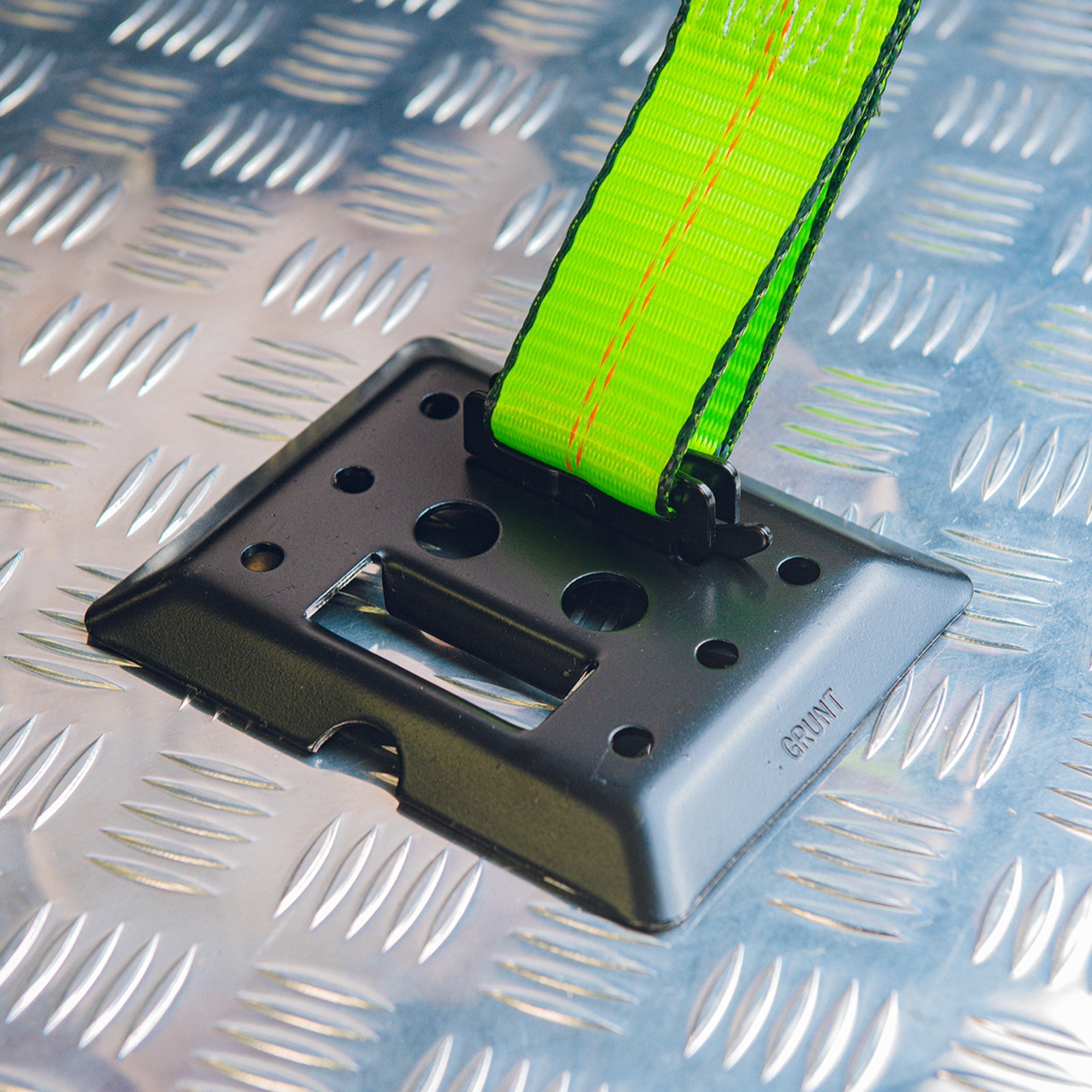GRUNT 50mm Black E Track Tie Off with D Ring – heavy-duty E-Track fitting with integrated D-ring for attaching ratchet straps and tie-downs in trailers and vans. Strong and secure snap-in design. Available at Bunnings AU and NZ.
