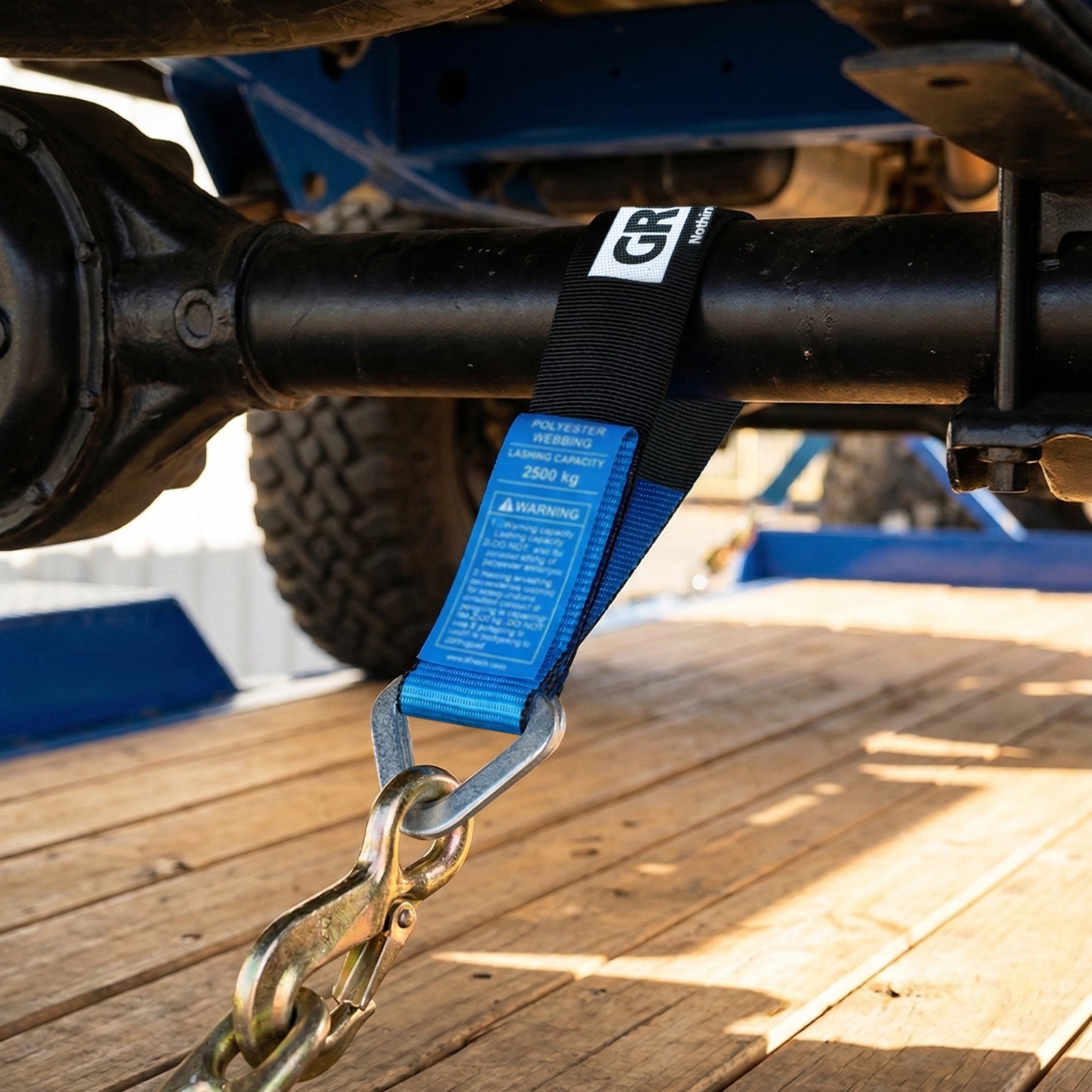 GRUNT 50mm x 60cm Blue and Black Heavy Duty Axle Strap – strong reinforced axle strap for vehicle recovery, towing, and wheel-lift towing applications. High working load for safe vehicle transport. Available at Bunnings AU and NZ.