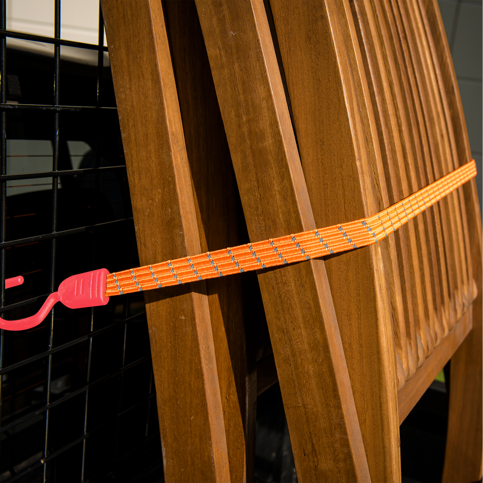 GRUNT 80cm Fluro Orange Reflecta Flat Bungee Strap – high-visibility reflective flat bungee strap for securing loads on racks, trailers, and bikes. Bright orange for day and night safety. Available at Bunnings AU and NZ.