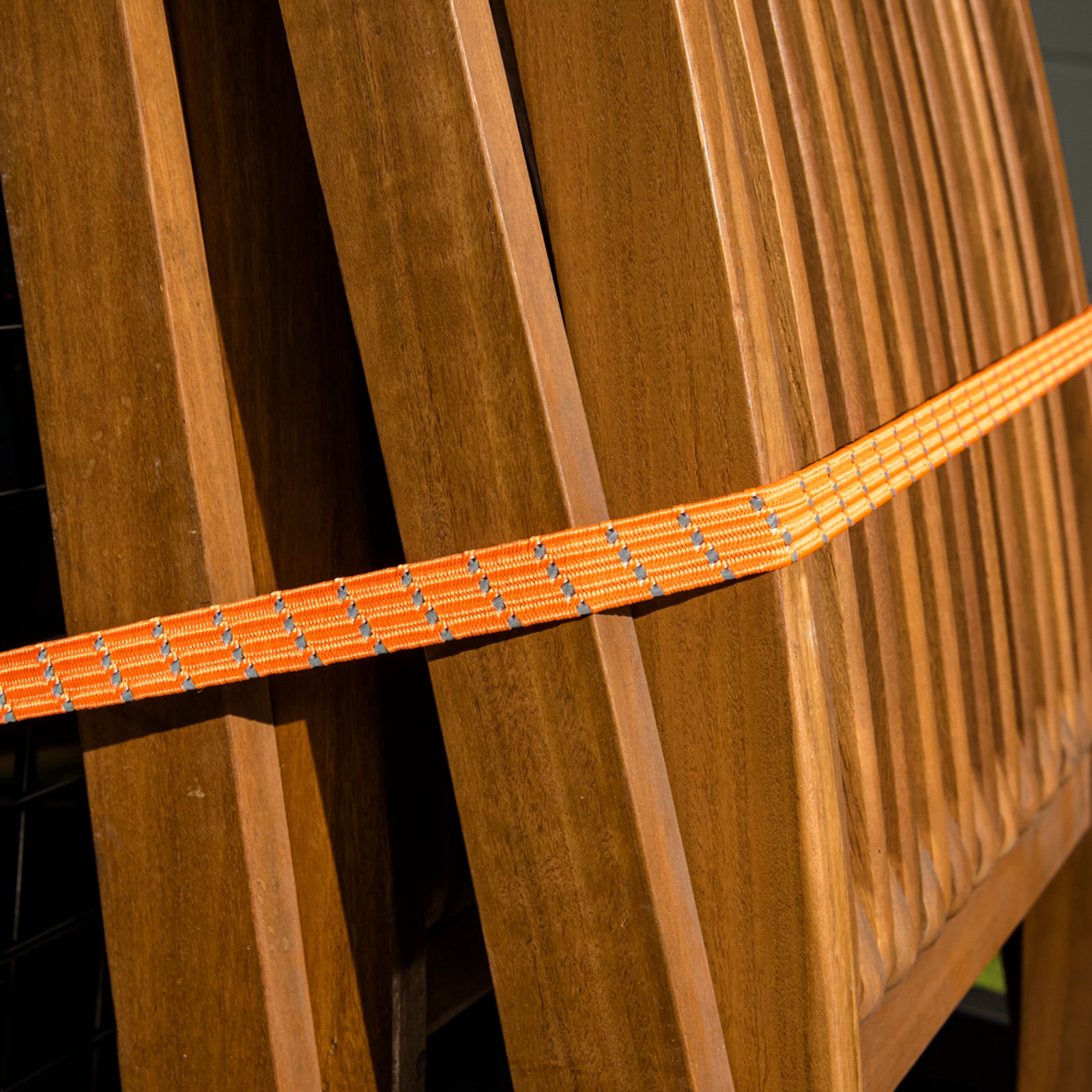 GRUNT 80cm Fluro Orange Reflecta Flat Bungee Strap – high-visibility reflective flat bungee strap for securing loads on racks, trailers, and bikes. Bright orange for day and night safety. Available at Bunnings AU and NZ.